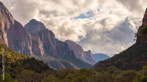 Timelapse of Dramatic clouds over Zion National Park's sandstone cliffs.