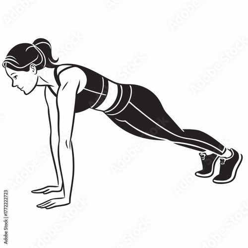 A fit woman with her hair in a ponytail performs a plank exercise in a sports bra and leggings demonstrating strength and dedication to fitness