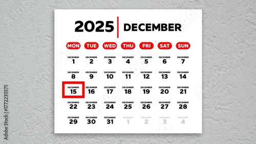 The date December 15th marked with a red cursor on the wall calendar 2025