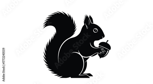 Silhouette of a squirrel holding an acorn, a charming vector illustration, perfect for naturethemed designs