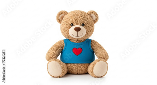 Charming teddy bear in a blue shirt with a red heart, sitting upright and looking forward with a smile