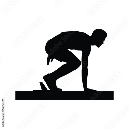 Silhouette of a runner in starting blocks ready to sprint