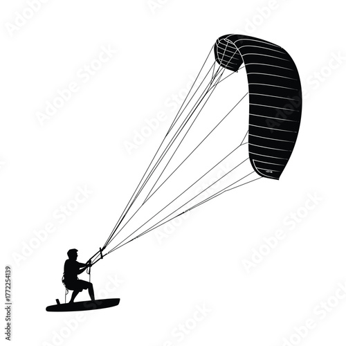 Silhouette of a kitesurfer riding a board with a large kite