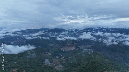 Green mountain valley landscape in Kunming,Mountains and clouds in Kunming, Yunnan,Natural mountain scenery in Kunming,Kunming valley surrounded by green hills,Misty mountain forest in Kunming