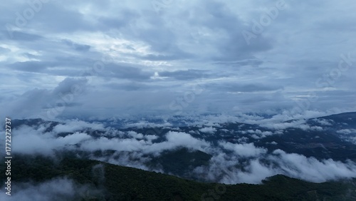 Green mountain valley landscape in Kunming,Mountains and clouds in Kunming, Yunnan,Natural mountain scenery in Kunming,Kunming valley surrounded by green hills,Misty mountain forest in Kunming