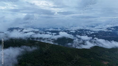 Green mountain valley landscape in Kunming,Mountains and clouds in Kunming, Yunnan,Natural mountain scenery in Kunming,Kunming valley surrounded by green hills,Misty mountain forest in Kunming
