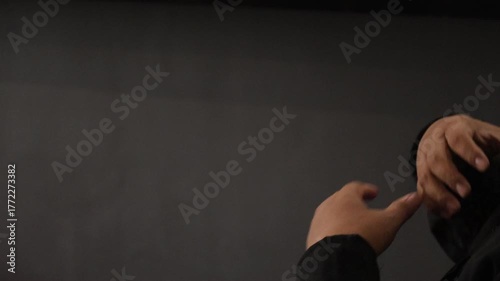 Sign language interpreters (JBI) use sign language while sitting in front of a camera.
