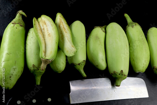 Home grown organic Green Brinjal, also known as eggplant arranged  in a row.