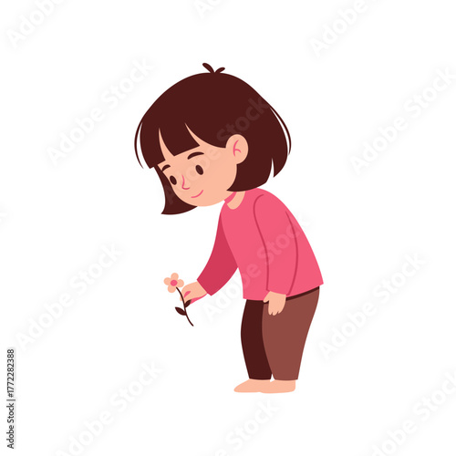 A young girl, smiling, gently picking a small, delicate flower.