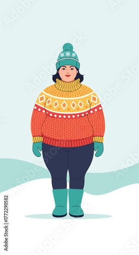 Cheerful woman in winter mood wearing colorful sweater and hat in snowy landscape