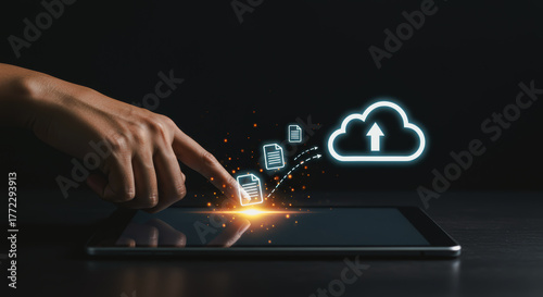 A hand interacts with a digital tablet, symbolizing cloud data storage, representing the intersection of technology and accessibility.