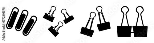 A collection of office supplies including paper clips and binder clips, isolated on a white background