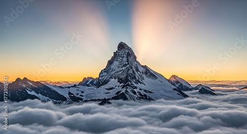 Majestic snow-capped mountain peak pierces through a sea of clouds at sunrise, bathed in golden light and dramatic sunbeams reaching across the sky.