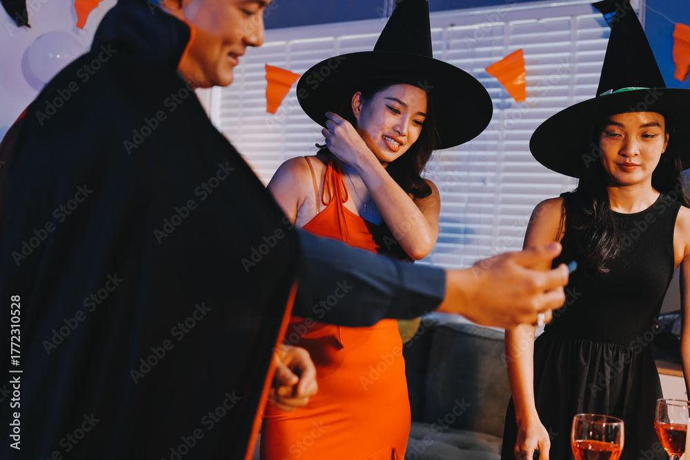 Obraz premium Joyful office Halloween party with coworkers in costumes, celebrating with drinks and laughter, fostering teamwork and festive spirit