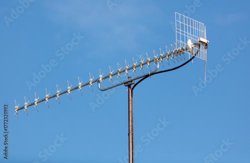 A large antenna is on a pole