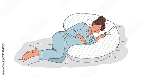 A pregnant woman sleeps on her side supported by a Ushaped pregnancy pillow with light blue polka dots