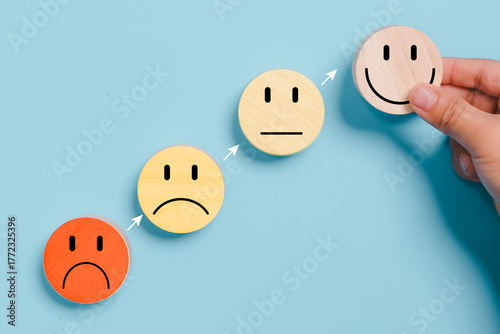 Hands holding blue happy smile face for medical care concept. Mental health positive thinking.