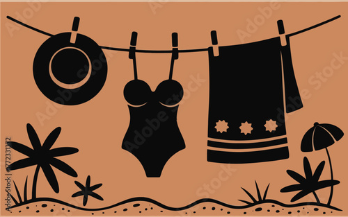 Black swimsuit and towel drying on clothesline with beach elements
