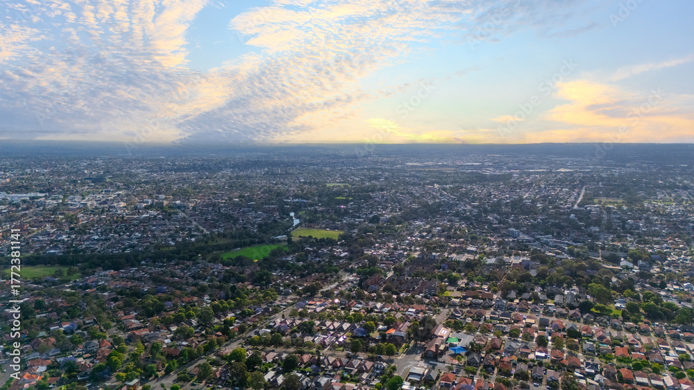 Obraz premium Panorama Sunset aerial drone view of western Sydney Suburbs of Canterbury Burwood Ashfield Marrickville Campsie with Houses roads and parks in Sydney New South Wales NSW Australia