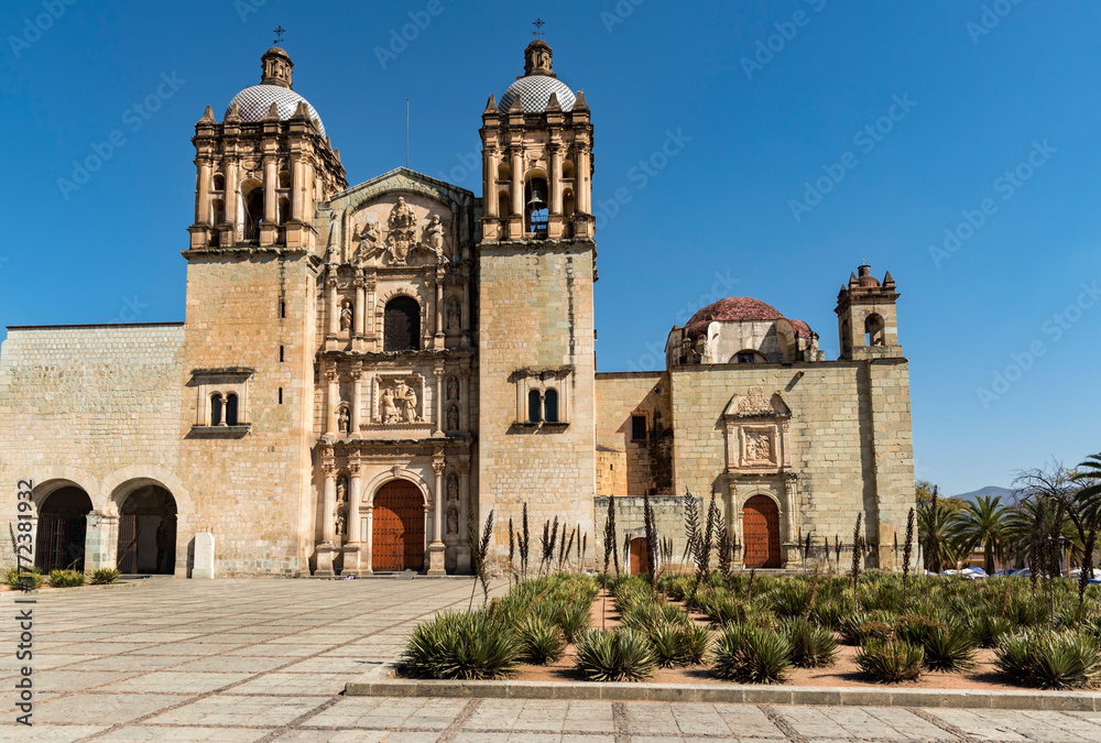 Fototapeta premium Front of the Church of Santo Domingo in Oaxaca, view from below, garden in the foreground