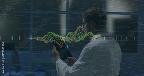 Scientist wearing lab coat holding tablet analyzing floating line chart inside lab with stations