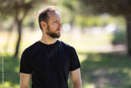 Young man looking away contemplating future outdoors