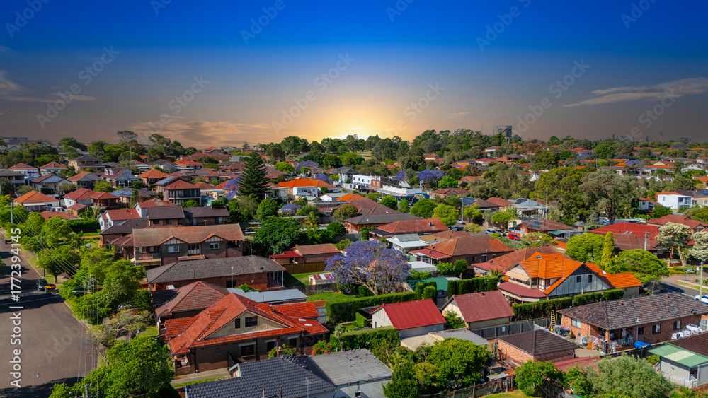 Fototapeta premium Panorama Sunset aerial drone view of western Sydney Suburbs of Canterbury Burwood Ashfield Marrickville Campsie with Houses roads and parks in Sydney New South Wales NSW Australia
