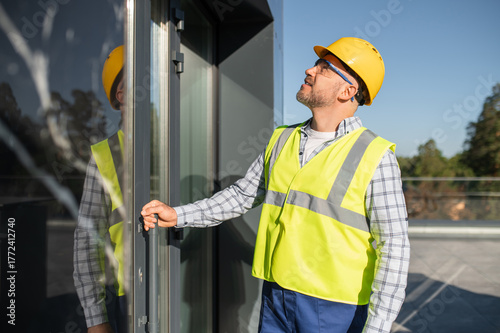Engineer inspecting modern building facade
