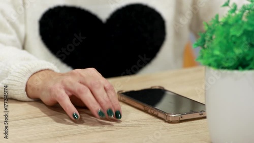 hand holding mobile phone waiting for a message or reply