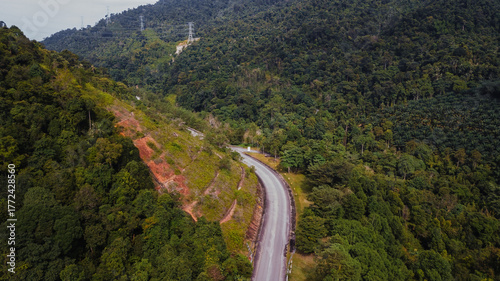 An aerial view of the road across the rainforest mountains in Hulu Selangor, Malaysia.