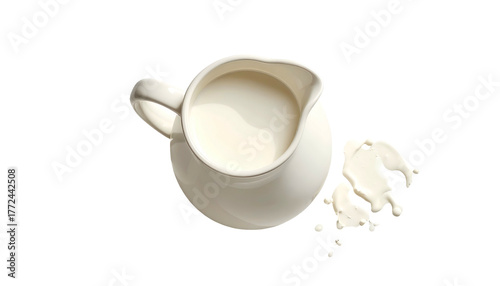 Creamy milk in a white pitcher with spill on black background