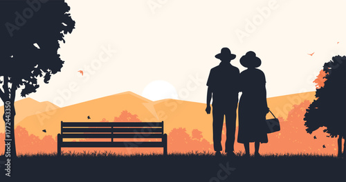 Elderly couple silhouette standing and gazing at the mountains in autumn beside a park bench.