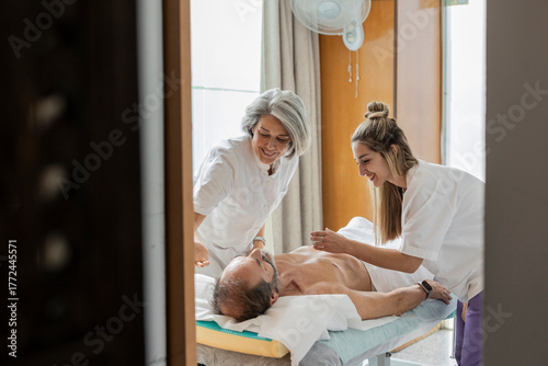 Acupuncturist performing acupuncture treatment for pain relief in clinic