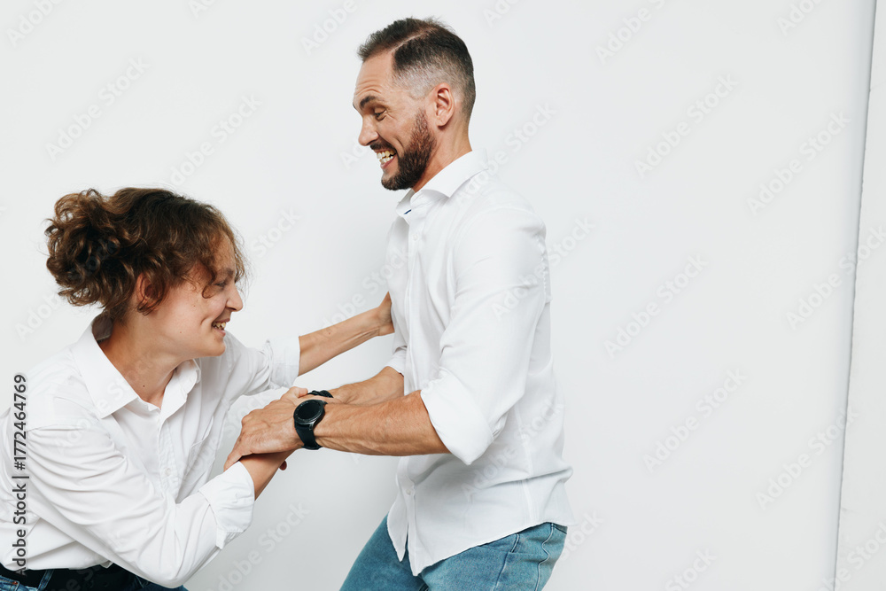 Obraz premium Businessman in a white shirt stands with a colleague against a pure white background, exuding confidence, focus, and positive energy in a professional setting.