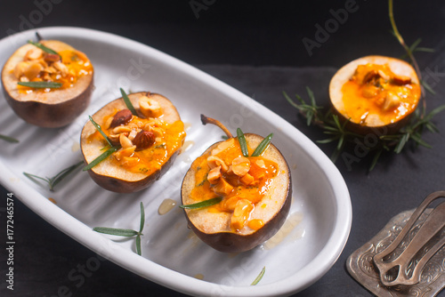 Roasted Pears with Blue Cheese nuts and Honey on black background with copy space