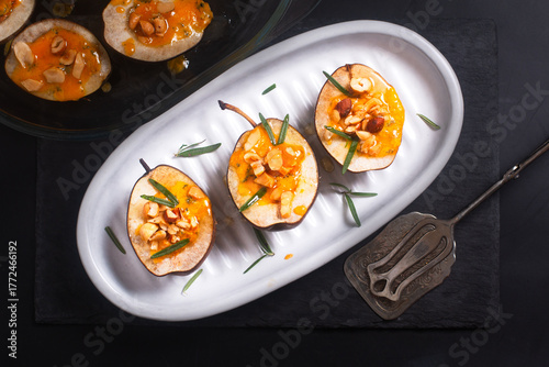 Roasted Pears with Blue Cheese nuts and Honey on black background with copy space