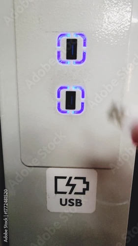 Vertical charger.  The hand connects the charger wire.

