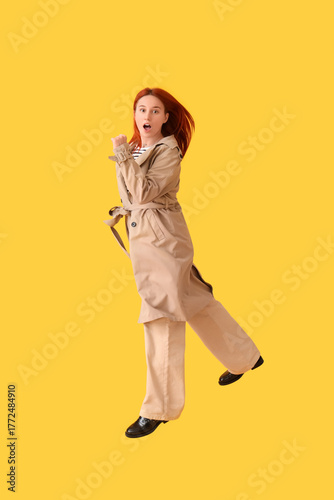 Jumping young woman in autu...