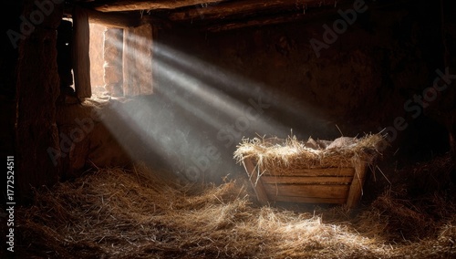 The baby's cradle in the manger, illuminated by rays of light streaming through an open window.
