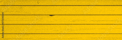 Yellow rustic wood background with grainy, crack and roughness. Wooden stipple effect overlay. Natural weathered and rural style for design projects.