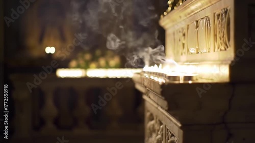 Close Up of Row of Candles with Smoke Rising in Dimly Lit Interior