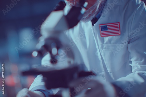 Microscope work in USA laboratory showcasing a scientist dedicated to research and innovation while proudly displaying the American flag on their lab coat