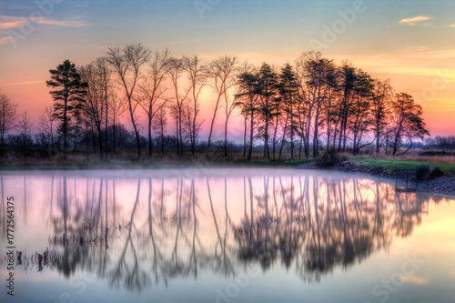 sunrise over foggy lake