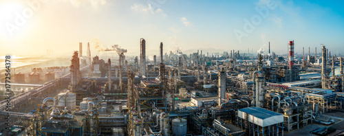 Aerial view of oil refinery and chemical plant with pipeline equipment in a large industrial area at sunrise