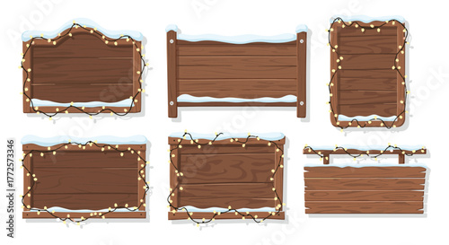 Collection of wooden signs with snow and festive lights for winter decor
