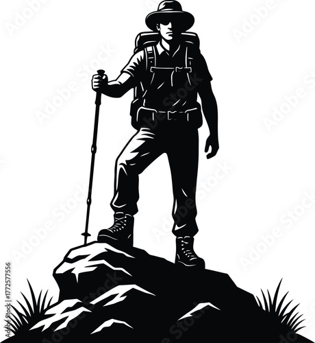 Silhouette of Hiker Standing on Mountain Peak with Backpack and Walking Stick