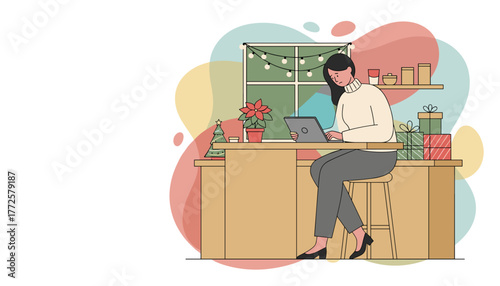 Remote worker busy on laptop at home counter decorated for the winter holiday season