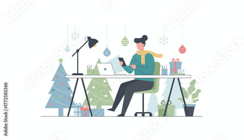 Remote worker uses phone and laptop at a festive desk decorated for Christmas and winter holidays