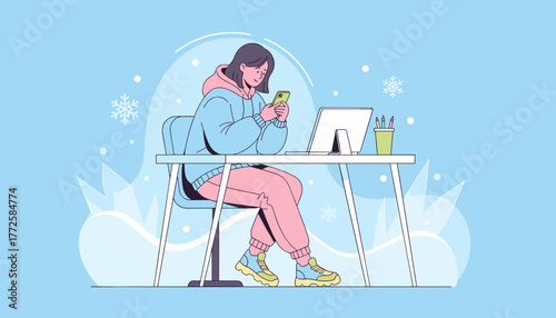 Young woman using a smartphone at her desk during a winter remote work or study session
