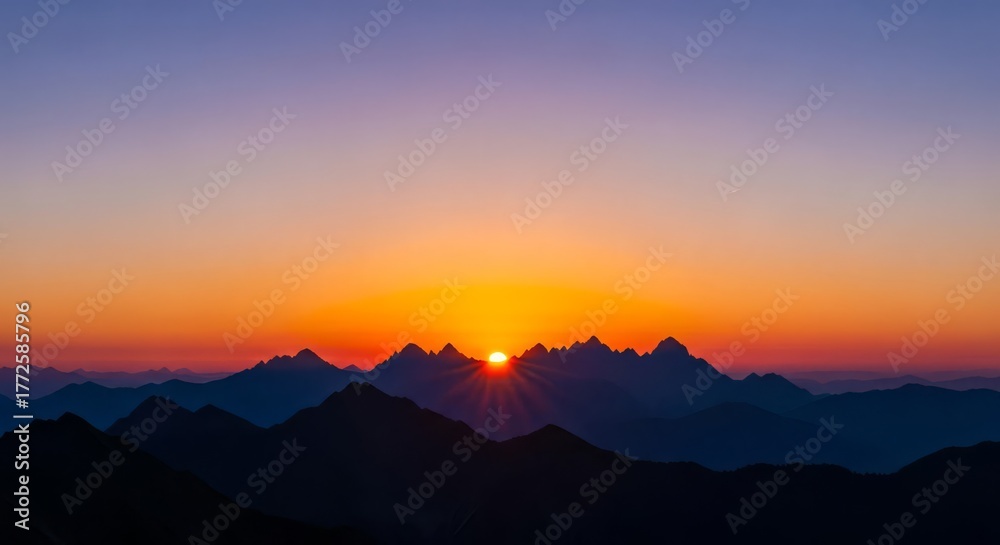 Fototapeta premium Dramatic Sunset over Silhouetted Mountain Range